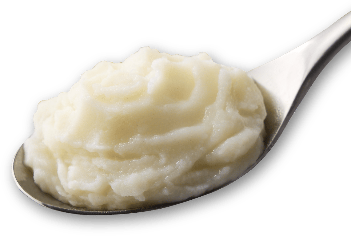 A close-up of a spoonful of creamy mashed potatoes against a white background.