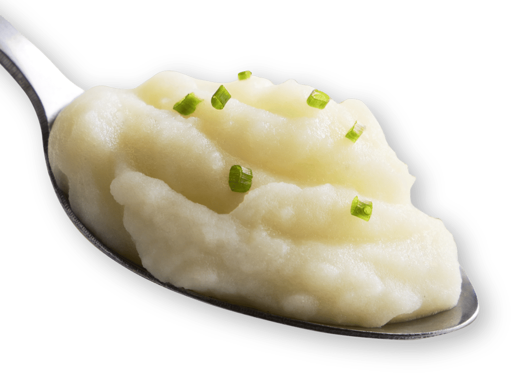 A spoonful of creamy mashed potatoes topped with small pieces of chopped chives, set against a white background.