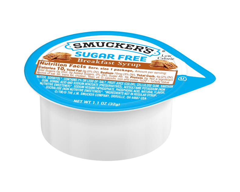 A small white plastic cup of Smuckers Sugar Free Breakfast Syrup with a blue and orange foil lid displaying product information and nutrition facts.