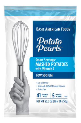 A box of Basic American Foods Potato Pearls® Smart Servings™ Mashed Potatoes with Vitamin C, featuring a hand holding a spatula, product details on the front.