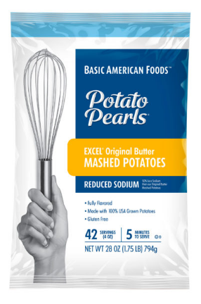 A box of Basic American Foods Potato Pearls® EXCEL® Original Butter Mashed Potatoes – Reduced Sodium, featuring a hand holding a spatula, product details on the front.